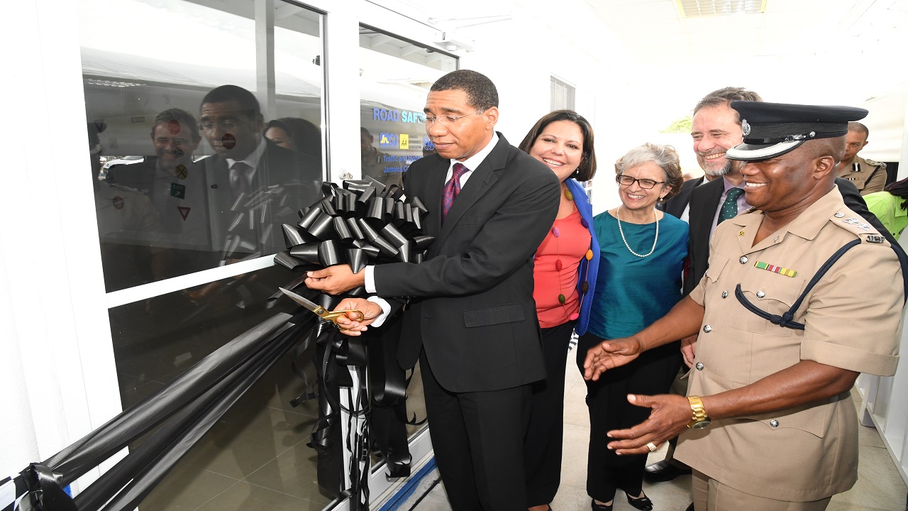 Prime Minister Andrew Holness cuts the ribbon to officially open the Road Safety Hub at the Traffic and Highway Division at the Elleston Road Police Station in Kingston on Wednesday. Sharing in the moment are (from right): Senior Superintendent of Police, Calvin Allen; Chris Hind, general manager, JN General Insurance (JNGI); Kathleen Moss, chairman of the JNGI Board and Saffrey Brown, general manager of the JN Foundation.