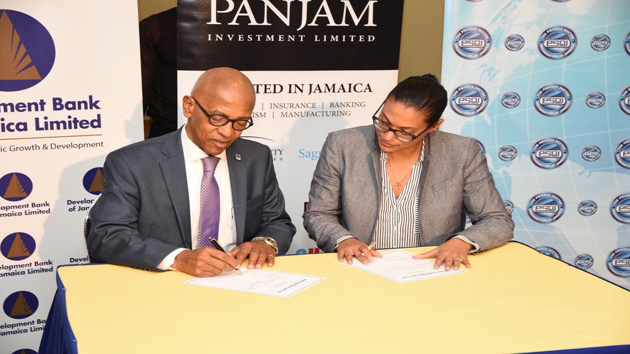 DBJ's Managing Director Milverton Reynolds signing the official sponsorship agreement with Platinum Sponsor PANJAM Investments VP New Business Development and Strategy, Joanna Banks.