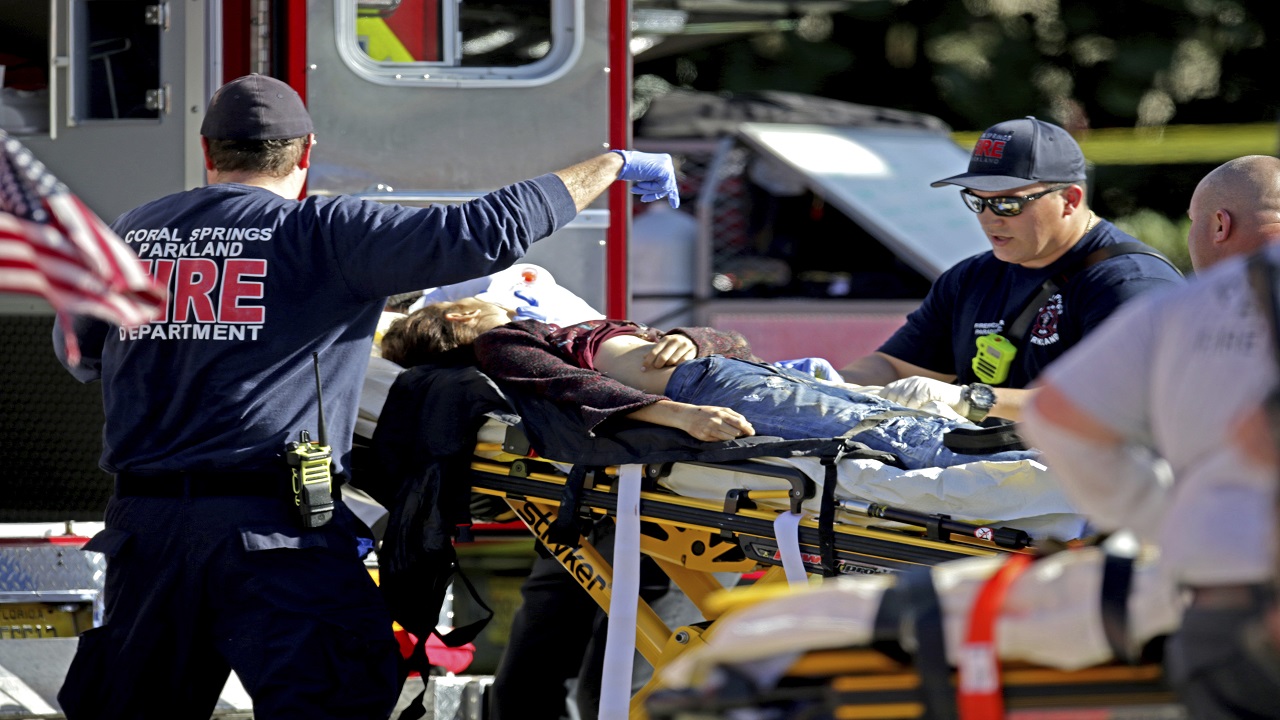 Medical personnel tend to a victim following a shooting at Marjory Stoneman Douglas High School in Parkland, Fla., on Wednesday, Feb. 14, 2018.