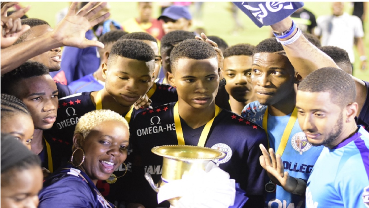 Jamaica College players get ready to hoist the Manning Cup after defeating St Andrew Technical High School in the finals at the National Stadium on Friday, December 1, 2018.  JC, which practice a vigorous recruitment drive, have won the Manning Cup for the last five years.