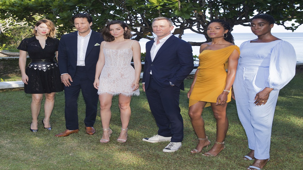 Actress Lea Seydoux, from left, director Cary Joji Fukunaga, actors Ana de Armas, Daniel Craig, Naomie Harris and Lashana Lynch pose for photographers during the photo call of the latest installment of the James Bond film franchise, currently known as 'Bond 25', in Oracabessa, St Mary. (AP: Photo)