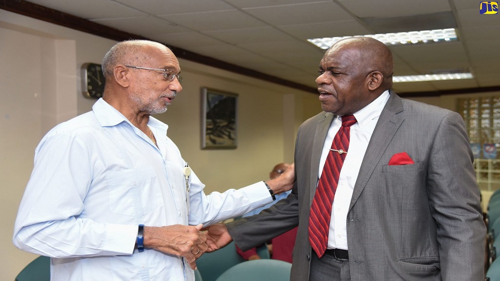 Director of the Centre for Disability Studies at the University of the West Indies (UWI), Mona Campus, Senator Floyd Morris (right), greets patron of the National Child Month Committee (NCMC), Douglas Orane, at the launch of Child Month 2019, which was held recently at GraceKennedy’s office in downtown Kingston.