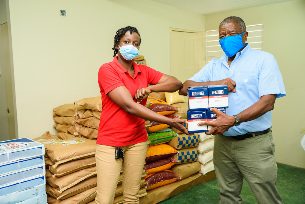 Nicola Morris, Administrator at the Black River Hospital and a board member of Directors’ Warden at the All Souls Anglican Church is delighted to receive masks from Donald Mullings, founder & managing director, M & M Jamaica Limited, for the Black River Hospital. 