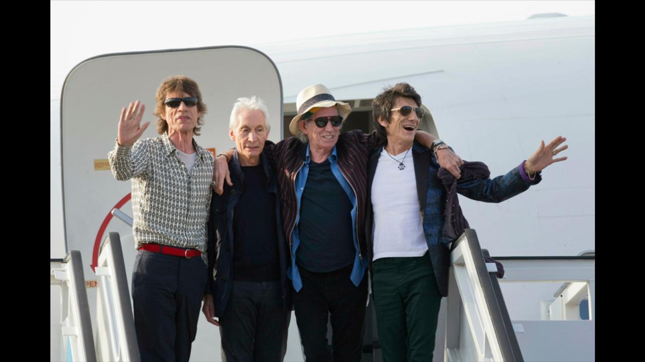 In this March 24, 2016 file photo, members of The Rolling Stones, from left, Mick Jagger, Charlie Watts, Keith Richards and Ron Wood pose for photos from their plane at Jose Marti international airport in Havana, Cuba. The Rolling Stones are threatening U.S. President Donald Trump with legal action for using their songs at his reelection campaign rallies despite cease-and-desist directives, according to a statement issued by the band Sunday June 28, 2020. (AP Photo/Ramon Espinosa File)