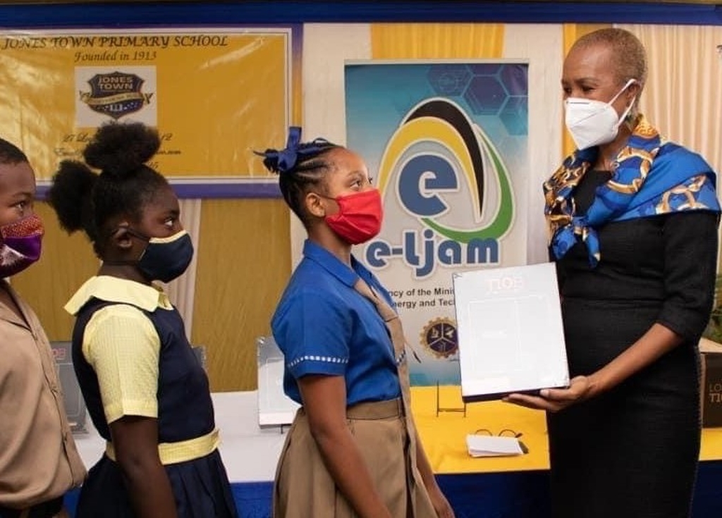 Education Minister Fayval Williams and three of the beneficiaries during the recent handing over ceremony.