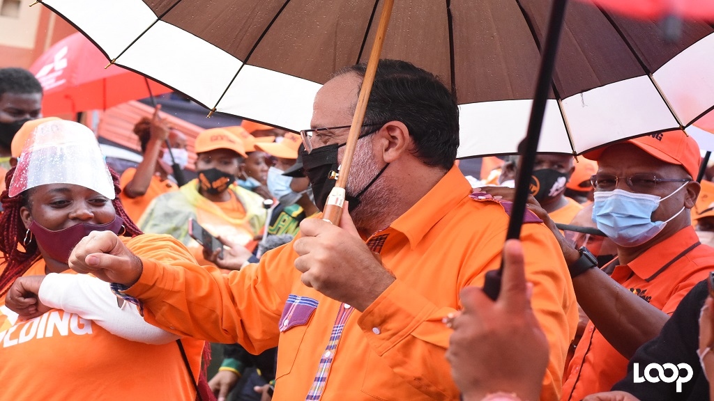 PNP presidential candidate Mark Golding (centre) elbow bumps a supporter. Golding's friend, former Central Manchester MP Peter Bunting (right) shares in the occasion. (Photos: Marlon Reid)