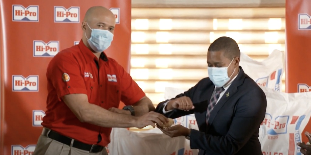 Col. Jaimie Ogilvie (left) Vice President of Hi-Pro Division of the Jamaica Broilers Group hands 20,000 baby chicks to Floyd Green, Minister of Agriculture & Fisheries at a presentation ceremony held on December 16 at the JBG’s Corporate Offices, McCook’s Pen, St Catherine.