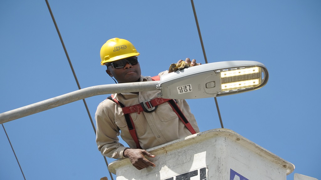 In this file photo, a worker completes a streetlight installation.