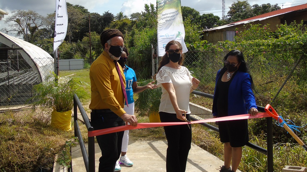 Photo L-R: Chairman of the Couva/Tabaquite/Talparo Regional Corporation, Henry Awong, Randi Davis, Resident Representative, UNDP TT, Jennifer Massiah, National Director, Habitat for Humanity TT stand at the launch of the first solar and wind-powered community greenhouse garden at Cashew Gardens.
