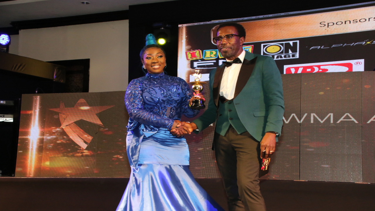 Spice collects her female deejay of the year award from entertainment journalist Winford Williams. (PHOTOS: Llewellyn Wynter)
