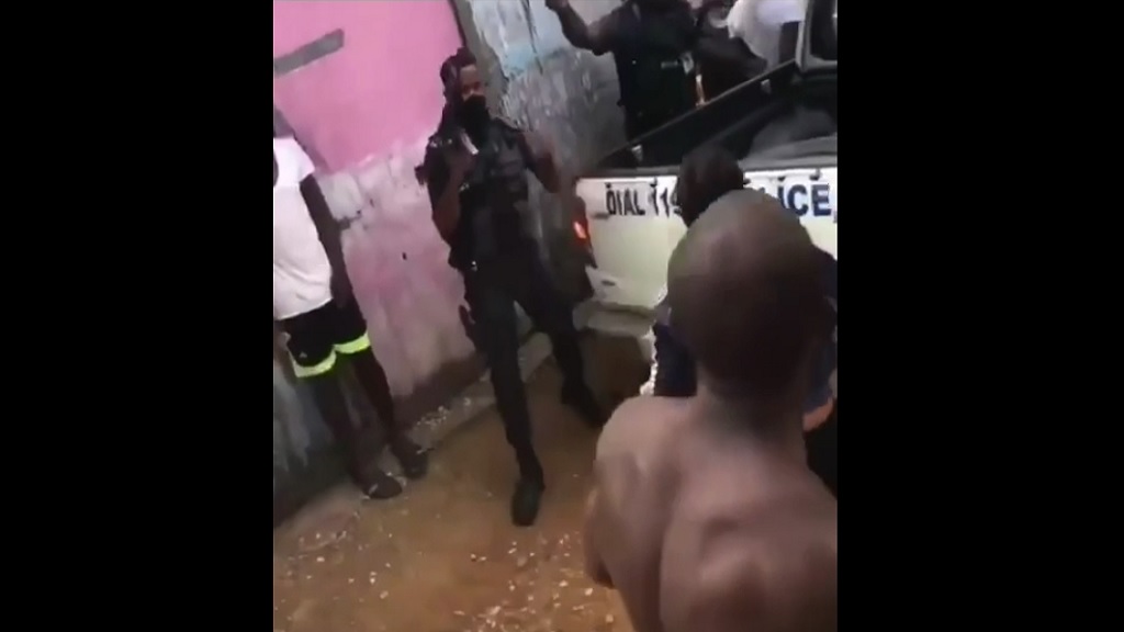 Cops staving off angry resident bent on jungle justice in Rhoden Hall, Clarendon on Sunday.