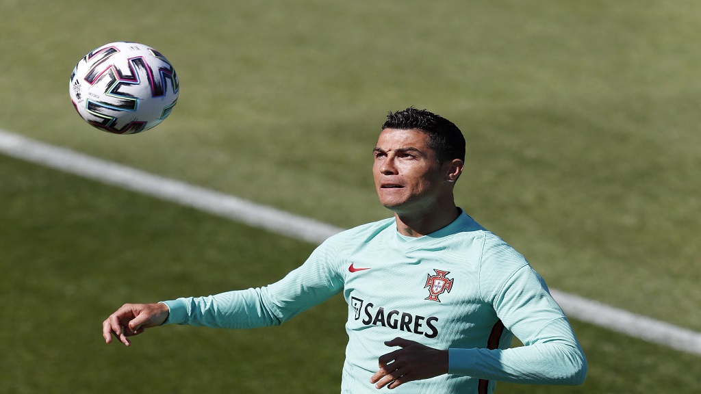 Portugal's Cristiano Ronaldo heads the ball during a team training