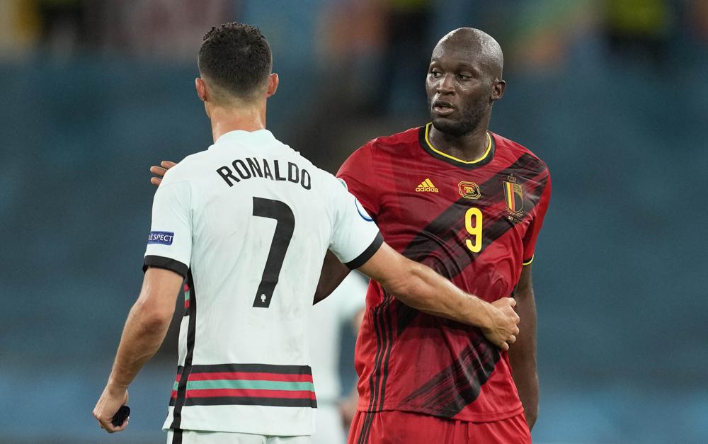 Portugal's Cristiano Ronaldo, left, and Belgium's Romelu Lukaku chat after the Euro 2020 soccer championship round of 16 match between Belgium and Portugal at the La Cartuja stadium in Seville, Spain,Sunday, June 27, 2021. (AP Photo/Thanassis Stavrakis, Pool)