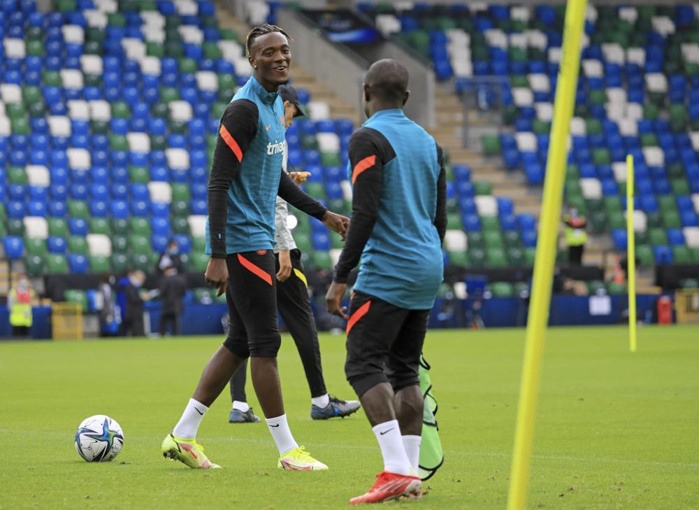 Chelsea's Tammy Abraham, left, looks at Chelsea's N'Golo Kante during a training session at Windsor Park in Belfast, Northern Ireland, Tuesday, Aug. 10, 2021. Chelsea and Villarreal will meet in the UEFA Super Cup in Belfast on Wednesday. (AP Photo/Peter Morrison)