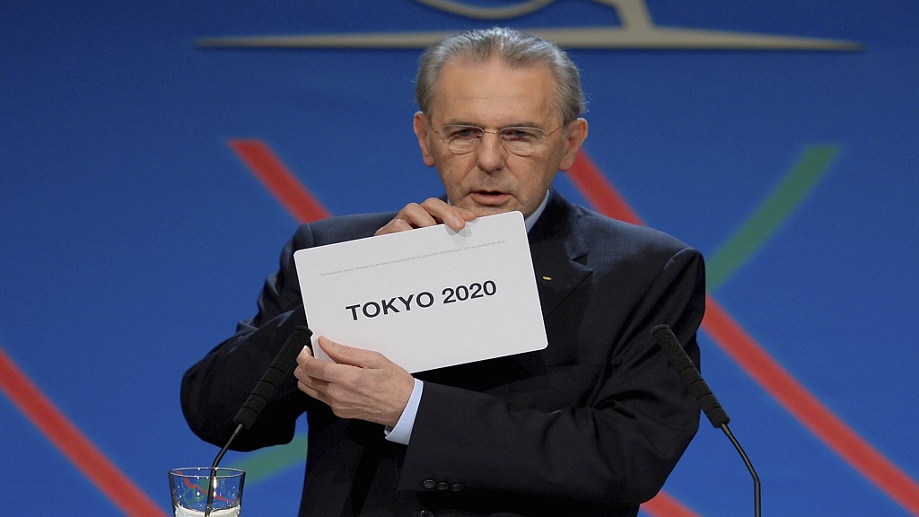 In this Saturday, Sept. 7, 2013 file photo, International Olympic Committee (IOC) president Jacques Rogge shows the name of the city of Tokyo elected to host the 2020 Summer Olympics in Buenos Aires, Argentina.  (Fabrice Coffrini/Pool photo via AP, file).