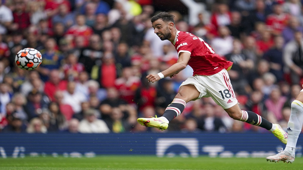 Manchester United's Bruno Fernandes scores his third goal during the English Premier League football match against Leeds United at Old Trafford in Manchester, England, Saturday, Aug. 14, 2021. (AP Photo/Jon Super).