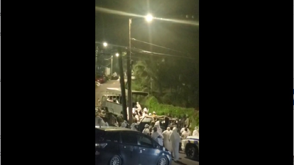 A screengrab from a video of members of a cult-like church in Albion, St James being detained by the security forces after a gun battle and three deaths on Sunday.