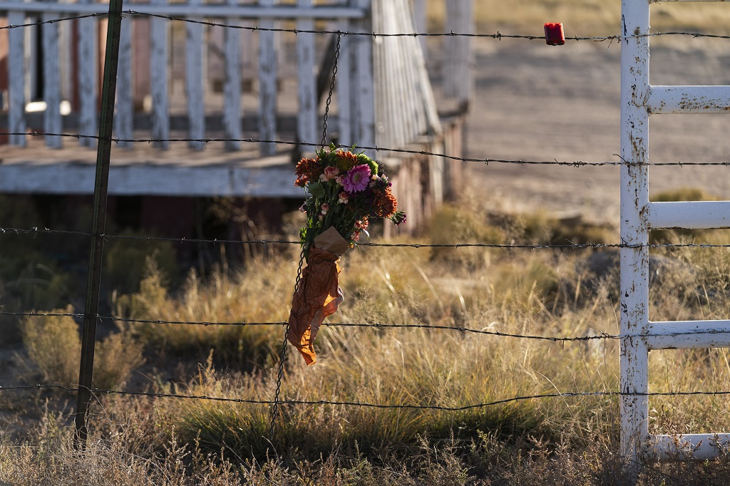 A bouquet of flowers is left to honor cinematographer Halyna Hutchins outside the Bonanza Creek Ranch in Santa Fe, N.M., Sunday, October 24, 2021. Hutchins died after actor Alec Baldwin fired a fatal gunshot from a prop gun that he had been told was safe. (AP Photo/Jae C. Hong)