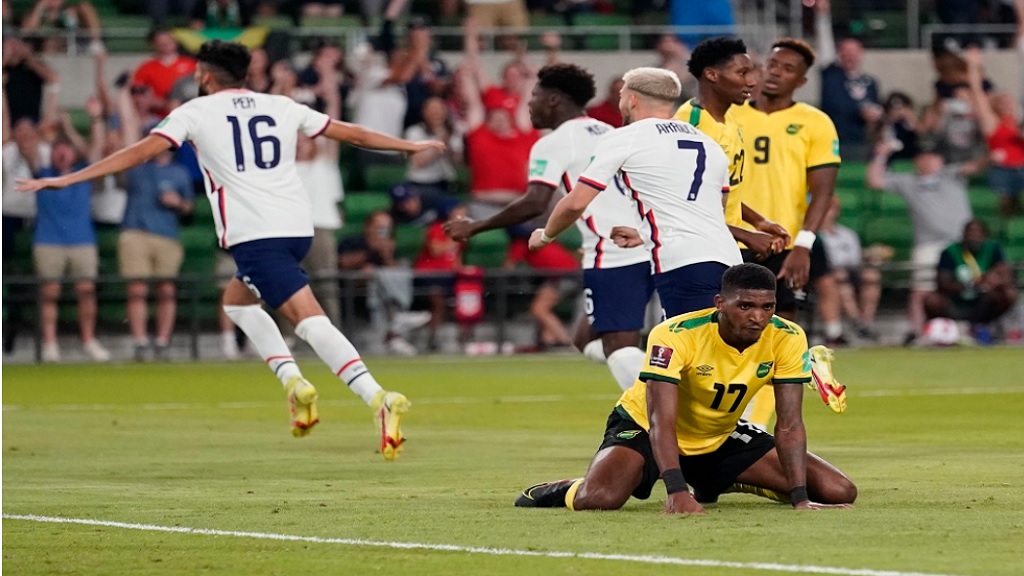 Jamaica's Damion Lowe (17) reacts as the United States celebrates a goal during a FIFA World Cup qualifying football match Thursday, Oct. 7, 2021, in Austin, Texas. 