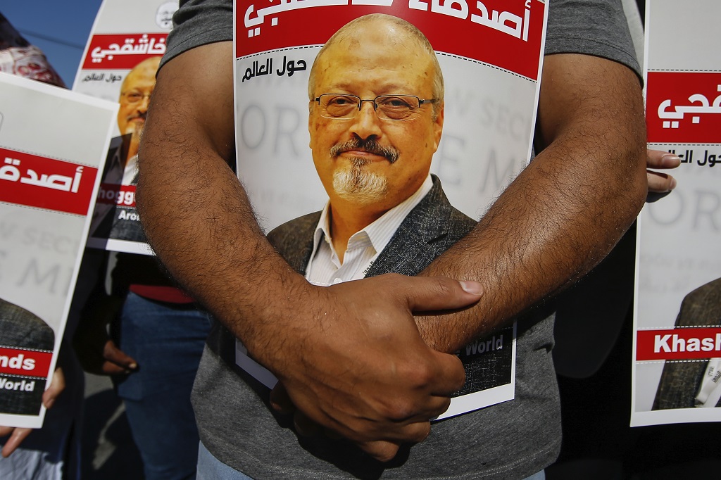 FILE - People hold posters of slain Saudi journalist Jamal Khashoggi, near the Saudi Arabia consulate in Istanbul, October 2, 2020, marking the two-year anniversary of his death. In a surprise development, the prosecutor in the case against 26 Saudi nationals charged in the slaying of Washington Post columnist Jamal Khashoggi requested Thursday March 31, 2022, that their trail in absentia be suspended and the case be transferred to Saudi Arabia. (AP Photo/Emrah Gurel, File)