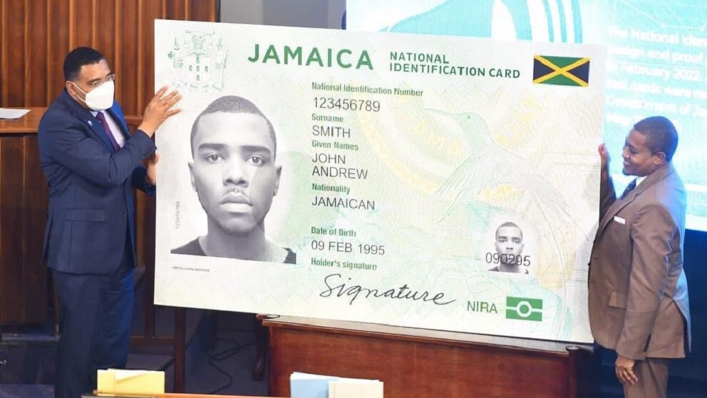 Prime Minister Andrew Holness (left) and Minister without portfolio in the Office of the Prime Minister, Floyd Green, unveil Jamaica's first national ID card in the House of Representatives on Tuesday. (Photo: Twitter via @AndrewHolnessJM)