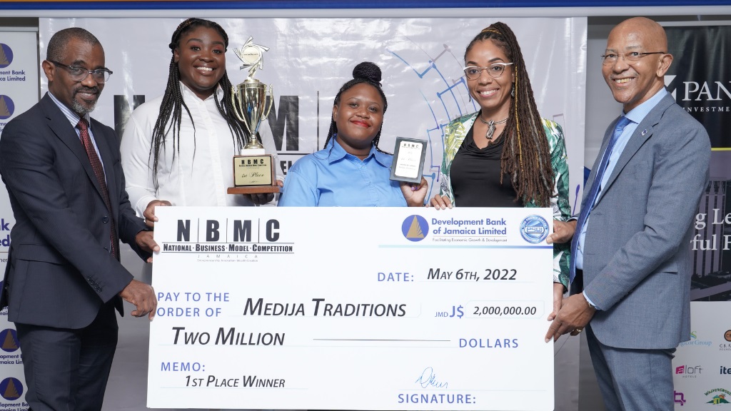 Medija Traditions, comprising University of Technology student entrepreneurs Shasantay Jennings (2nd left) and Shantay Siddo (centre), emerged as the winner of the National Business Model Competition last Friday. Current Managing Director Anthony Shaw (left) and outgoing Managing Director Milverton Reynolds (right) of the Development Bank of Jamaica also share the moment with Private Sector Organisation of Jamaica Executive Director Imega Breese McNab. 