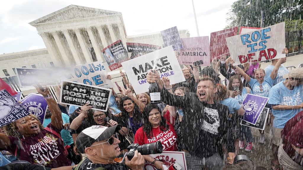 A celebration outside the Supreme Court, Friday, June 24, 2022, in Washington. The Supreme Court has ended constitutional protections for abortion that had been in place nearly 50 years — a decision by its conservative majority to overturn the court's landmark abortion cases. (AP Photo/Steve Helber)