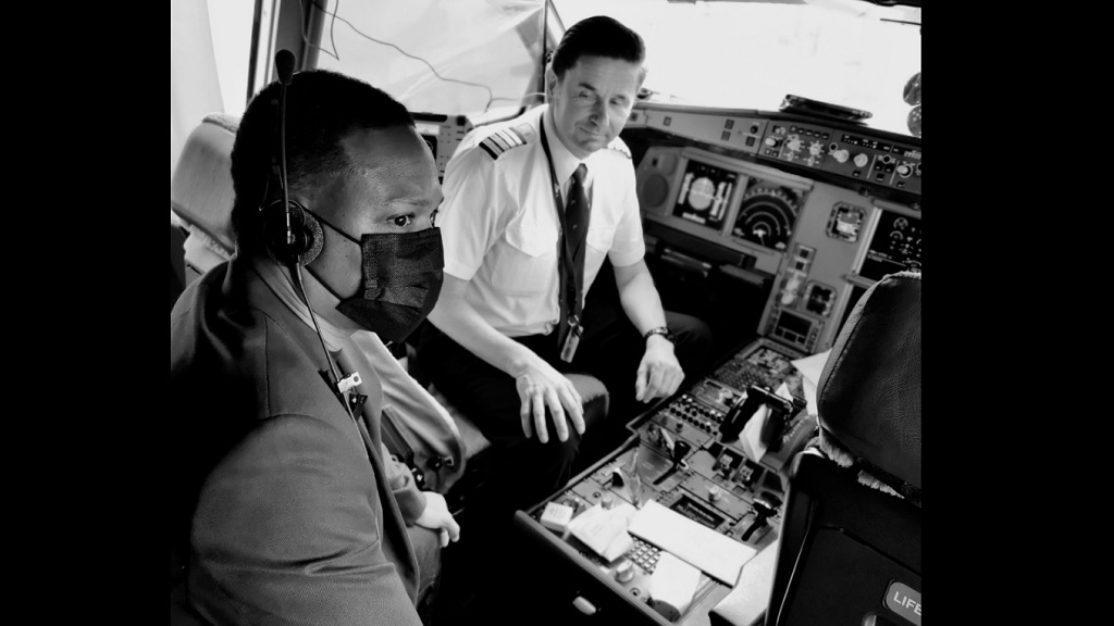 Dr Amery Browne sits in the cockpit of his flight to Amersterdam en route to CHOGM in Rwanda after a baby suffered a medical emergency.