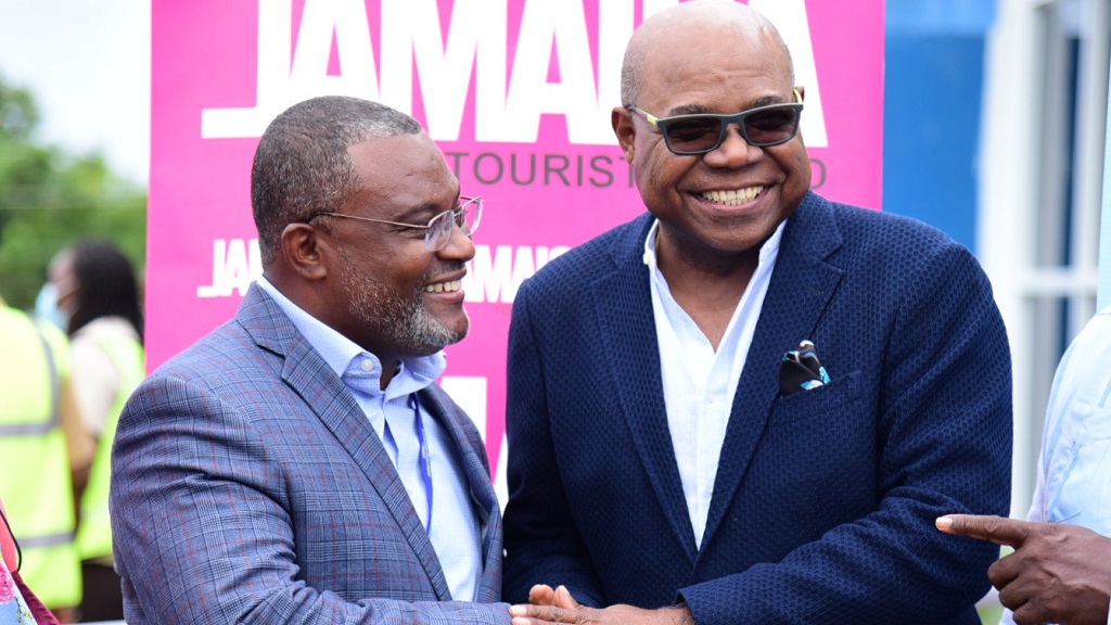 Minister of Tourism, Edmund Bartlett (right), greets Chairman of interCaribbean Airways, Lyndon Gardiner, when Jamaica welcomed its first scheduled commercial flight into the Ian Fleming International Airport on June 16, an interCaribbean Airways Embraer120. (Photo: JIS)