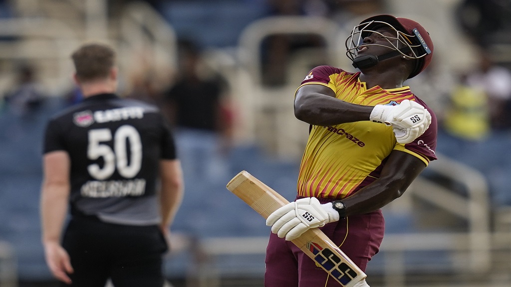 West Indies' captain Rovman Powell celebrates hitting a six to defeat New Zealand by eight wickets during the third T20 cricket match at Sabina Park in Kingston, Jamaica, Sunday, Aug. 14, 2022. (AP Photo/Ramon Espinosa).