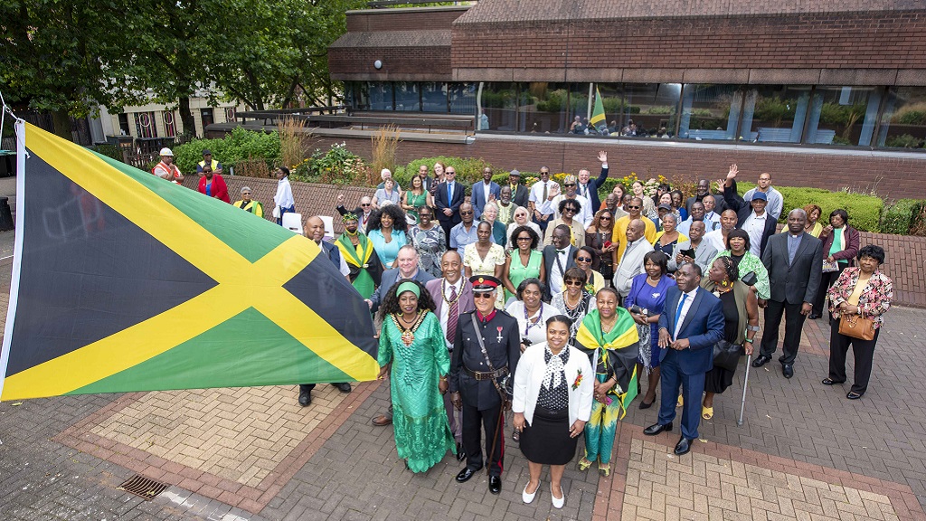 Jamaica-born Mayor of Wolverhampton, United Kingdom (UK), Councillor Sandra Samuels (left), holds a Jamaican flag at a civic function to mark Jamaica’s 60th Independence anniversary on August 6, 2022, at the African Caribbean Centre (The Hub) in Wolverhampton. Other officials and Jamaicans participated in the event.