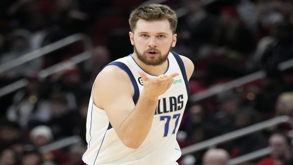 Dallas Mavericks guard Luka Doncic reacts after making a 3-point basket during the second half of an NBA basketball game against the Houston Rockets, Friday, Dec. 23, 2022, in Houston. (AP Photo/Eric Christian Smith).