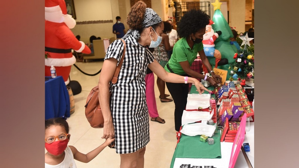 A patron checks out items on sale at a previous Suga Lifestyle Christmas Connection Trade Show. The event is back this Saturday, December 10, at the Jamaica Pegasus.