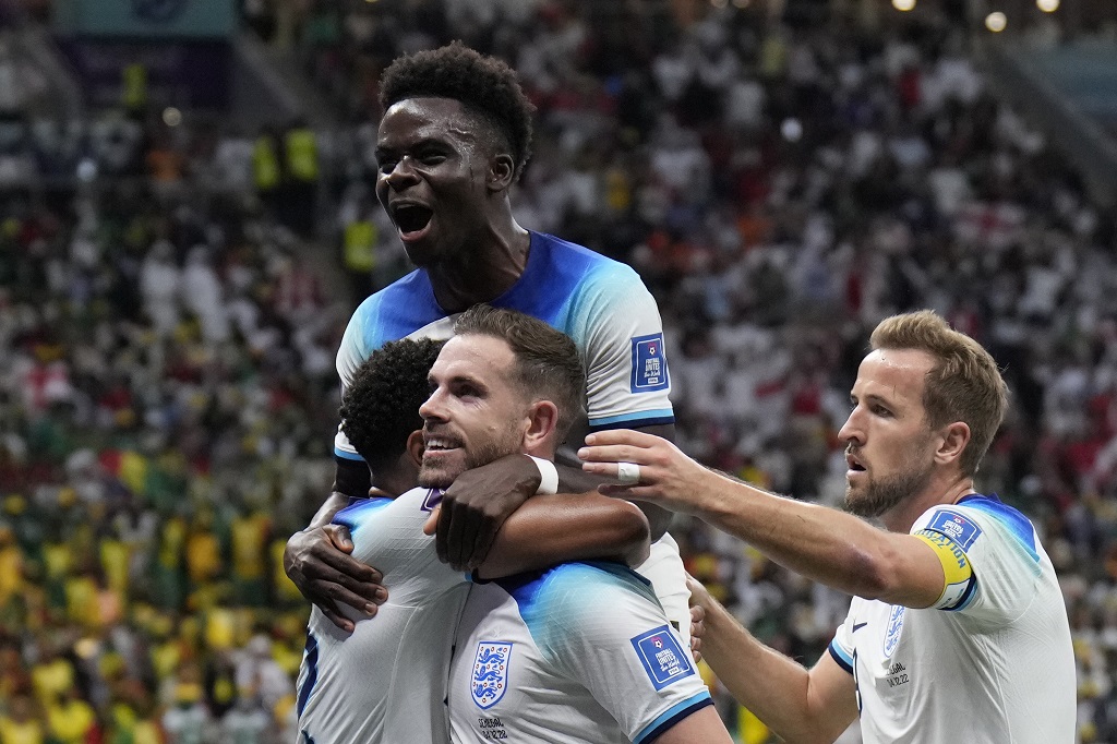 England's Jordan Henderson, centre, celebrates with his teammates after scoring his side's first goal during the World Cup round of 16 soccer match between England and Senegal, at the Al Bayt Stadium in Al Khor, Qatar, Sunday, December 4, 2022. (AP Photo/Hassan Ammar)