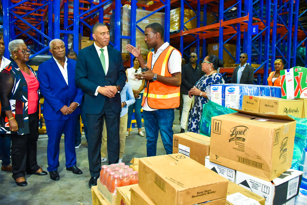Prime Minister Andrew Holness (centre), is briefed by Inbound Supervisor, Cari-Med Group, Christopher Meikle (second right), during a tour of the company’s new distribution centre in Bernard Lodge, St Catherine, which was officially opened on Friday (January 27). Others (from left) are Co-Founders, Cari-Med Group, Marva and Glen Christian, and Custos Rotulorum for St Catherine, Icilyn Golding.

