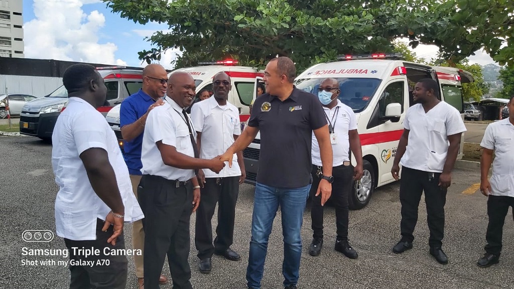 Health and Wellness Minister, Dr Christopher Tufton (centre, foreground) during the handing over of four ambulances to the Western Regional Health Authority (WRHA) on Friday. 