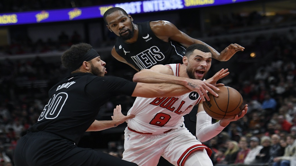 Chicago Bulls' Zach LaVine (8) drives against Brooklyn Nets' Kevin Durant and Seth Curry (30) during the second half of an NBA basketball game Wednesday, Jan. 4, 2023, in Chicago. The Bulls won 121-112. (AP Photo/Paul Beaty).