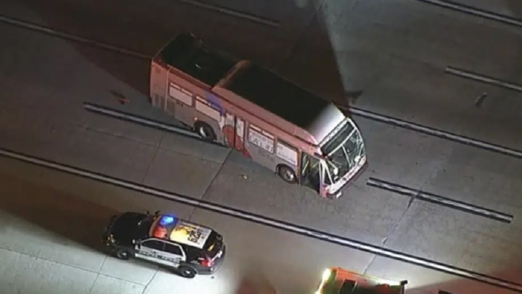 A passenger bus is damaged after a collision with an American Airlines aircraft early Saturday, Feb. 11, 2023 at Los Angeles International Airport, in Los Angeles. The jet being towed on a taxiway collided with a bus injuring five people. There was no interruption to operations at the airport. (KABC via AP)