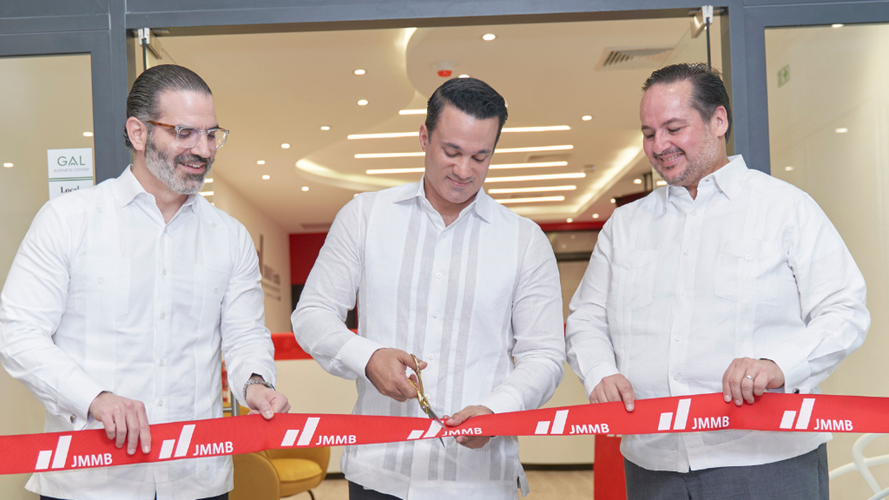 Juan Jose Melo, JMMB Group chief country officer in the DR CEO (centre) is assisted by Indalecio Lopez, JMMB Bank CEO (left) and Jesus Cornejo, JMMB Funds CEO in the symbolic ribbon cutting at the recent opening of the JMMB Group branch in Punta Cana in the Dominican Republic.