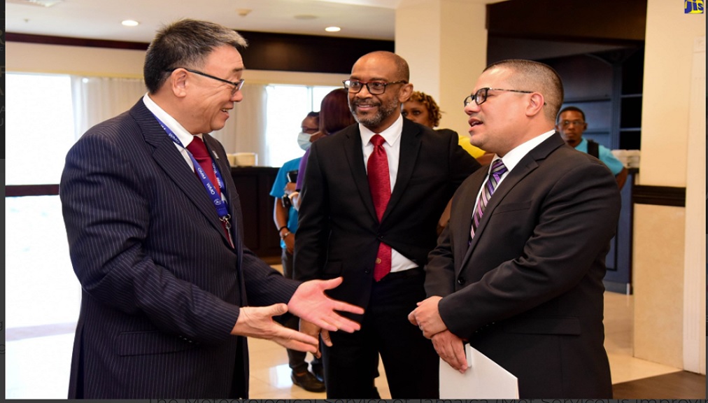 Minister without Portfolio in the Ministry of Economic Growth and Job Creation, Senator Matthew Samuda (right), is in conversation with World Meteorological Organization (WMO) Assistant Secretary General, Dr Wenjian Zhang (left) while President of the Regional Association IV, WMO, Evan Thompson, looks on