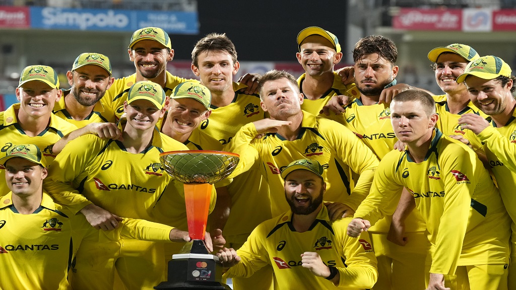 Australia's David Warner, centre, gestures as he and teammates pose with the winners trophy after their win in the third and last one day international cricket match against India in Chennai, India, Wednesday, March 22, 2023. Australia won the series 2-1. (AP Photo/Aijaz Rahi).


