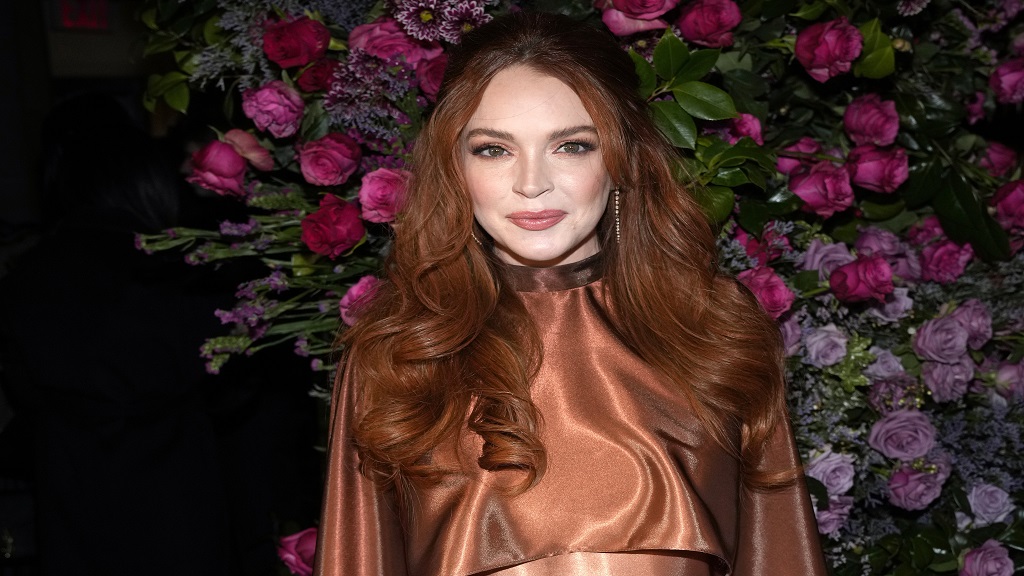 FILE - Actress Lindsay Lohan appears at the Christian Siriano Fall/Winter 2023 fashion show in New York, February 9, 2023. The Securities and Exchange Commission said Wednesday, March 22, that Lohan, rapper Akon and several other celebrities have agreed to pay tens of thousands of dollars to settle claims that they promoted crypto investments to their millions of social media followers without disclosing they were being paid to do so. (Photo by Charles Sykes/Invision/AP, File)