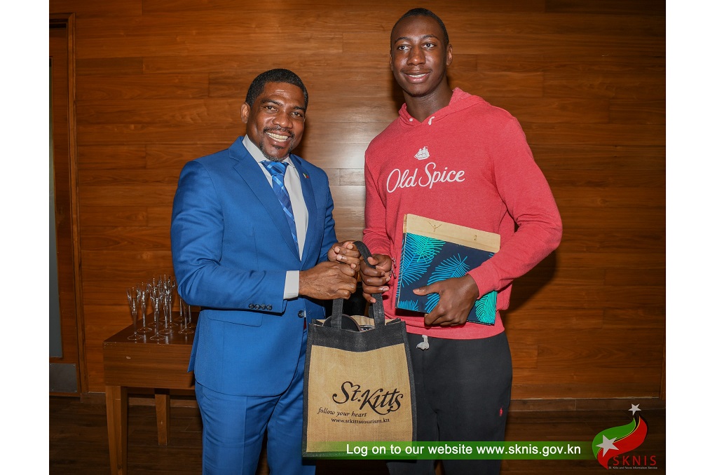 Prime Minister of St Kitts and Nevis Dr Terrance Drew greets NFL player, Joshua Williams, who has Kittitian roots. (Photo credit: SKNIS)