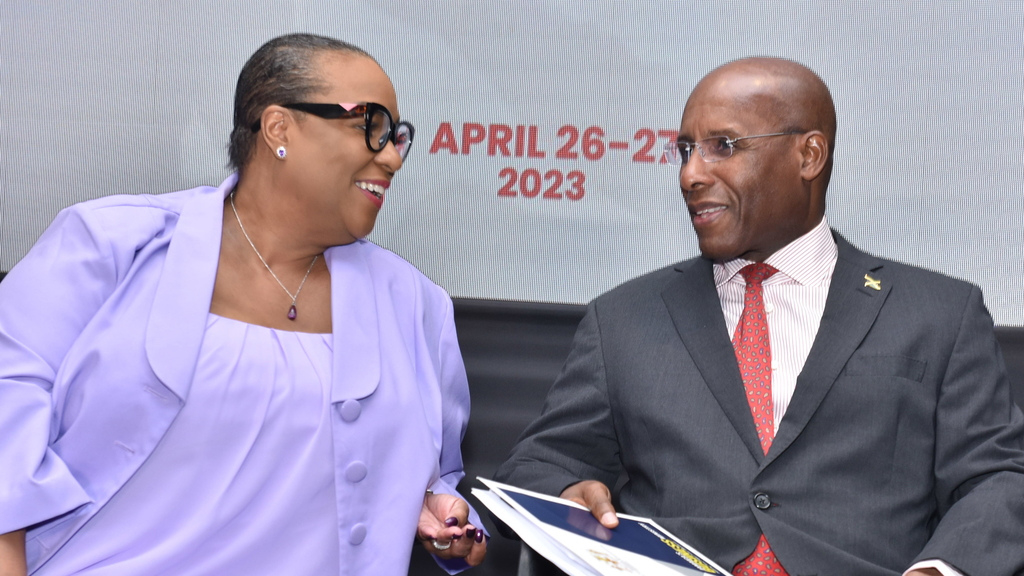 Dr Jacqueline Coke-Lloyd (left), CEO of the Make Your Mark Group, organiser of the Middle Managers’ Leadership Conference shares a word with Senator Aubyn Hill, Minister of Industry, Investments and Commerce.