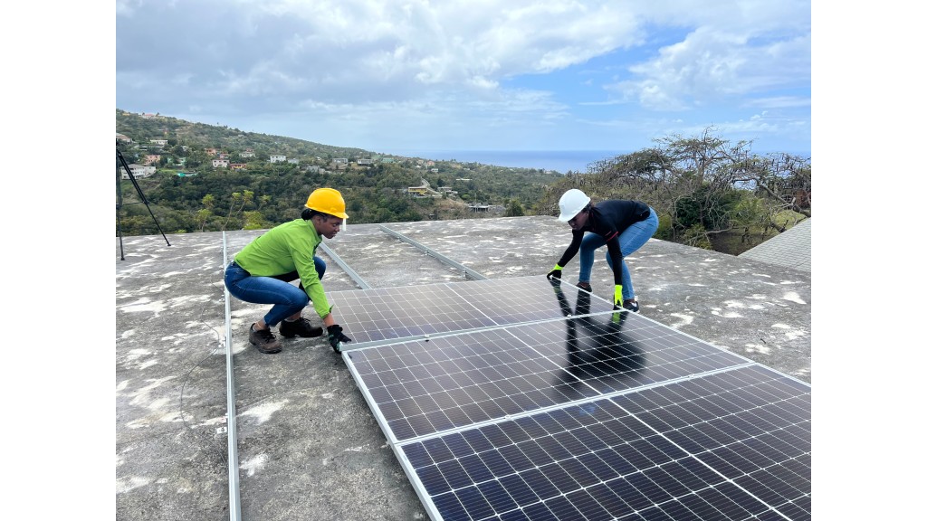 Taiyi West of the GSI team shows Trainee, Adia Page, how to install PV panels. Photo: GSI