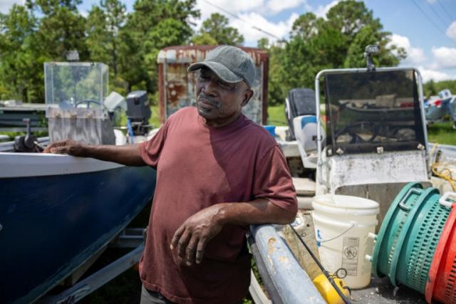 Fisherman Ed Atkins in front of his bait shop on Saint Helena Island, South Carolina, July 11, 2023 AFP  
