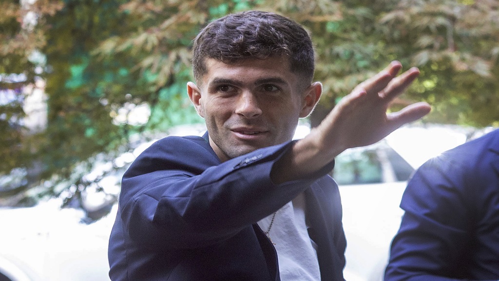 United States football player Christian Pulisic waves as he arrives in Milan, Italy, Wednesday, July 12, 2023, for medical tests at Italian Serie A  team AC Milan before an expected transfer from British club FC Chelsea. (Stefano Porta/LaPresse via AP).
