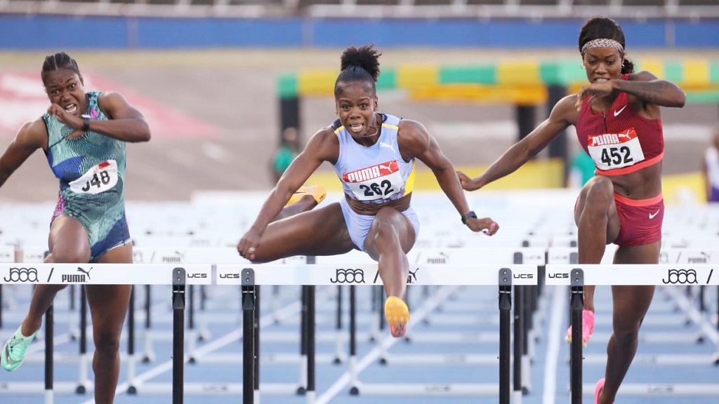 Megan Tapper (centre) races to victory in the women's 100m hurdles at the National Senior and Junior Championships at the National Stadium on Sunday, July 9, 2023. (PHOTO: Marlon Reid).