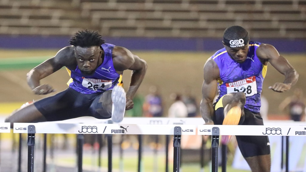 Rasheed Broadbell (left) races to victory in semi-final one of the men's 110m hurdles on day three of the National Senior and Junior Championships on Saturday, July 8, 2023. (PHOTO: Marlon Reid).
