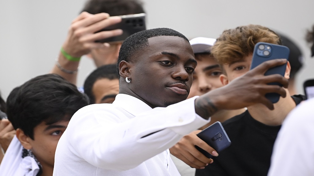 US football player Timothy Weah, front, takes a selfie as he arrives for fitness tests at the Italian football club Juventus F.C. in Turin, Italy, Thursday, June 29, 2023. (Fabio Ferrari/LaPresse via AP).